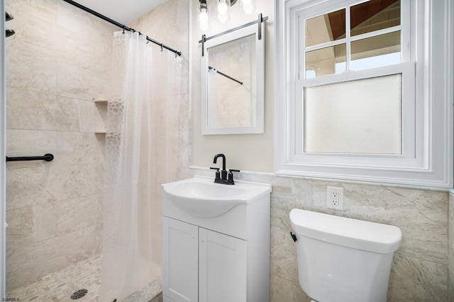 bathroom featuring vanity, curtained shower, tile walls, and a healthy amount of sunlight