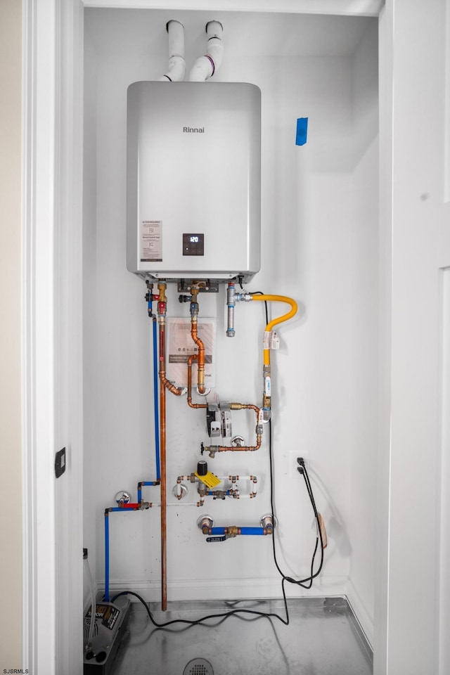 utility room featuring tankless water heater