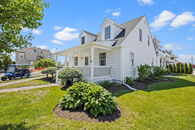 300 N Huntington, Margate, NJ 08402 - view of front of house featuring covered porch, roof with shingles, and a front lawn