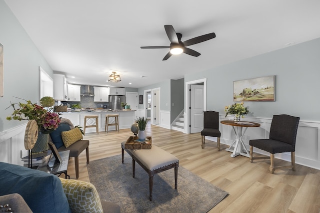 living room featuring ceiling fan and light wood-type flooring