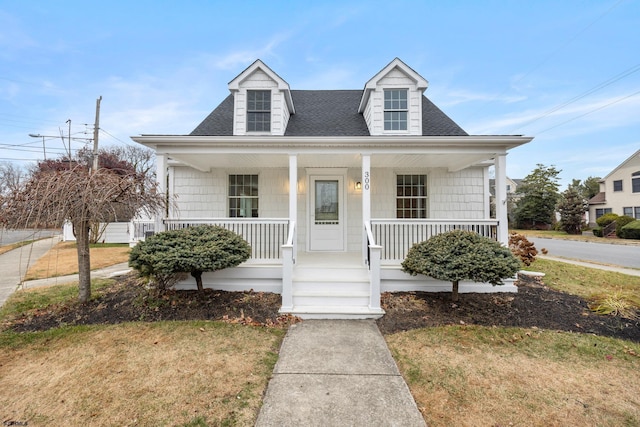 view of front of house featuring a porch and a front lawn