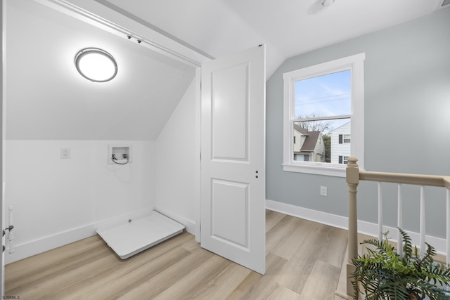 additional living space featuring light hardwood / wood-style floors and lofted ceiling