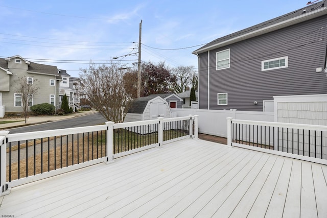 wooden terrace featuring a storage unit