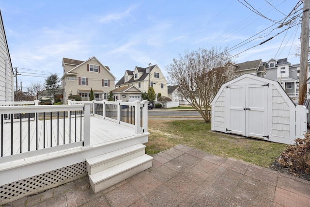 wooden terrace featuring a storage unit