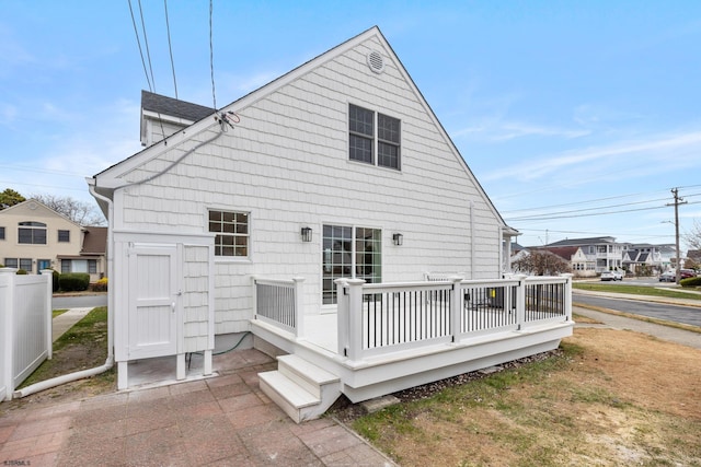 back of property with a wooden deck