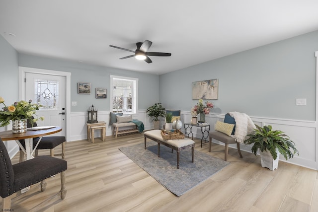 living room with ceiling fan and light wood-type flooring