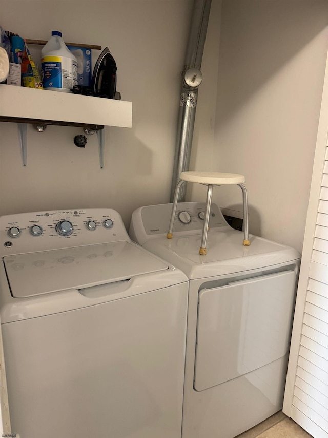 laundry area featuring separate washer and dryer and light tile patterned floors