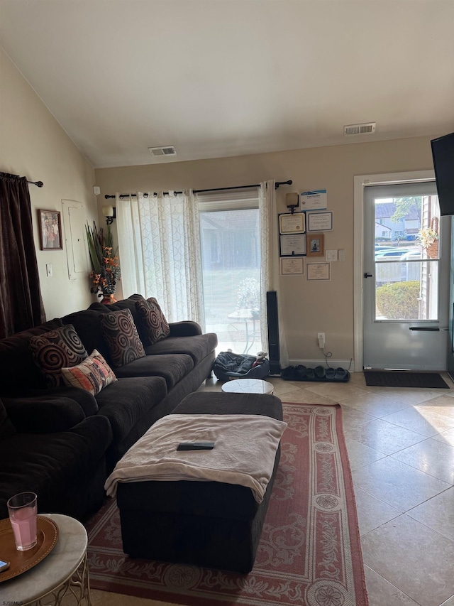 tiled living room featuring lofted ceiling