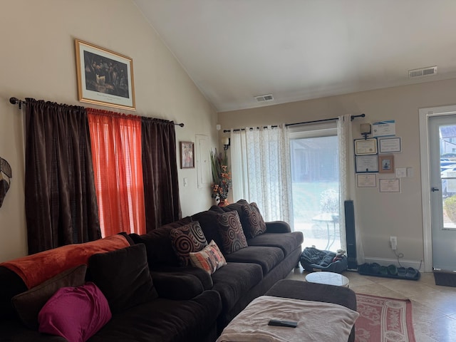 living room featuring lofted ceiling and light tile patterned floors