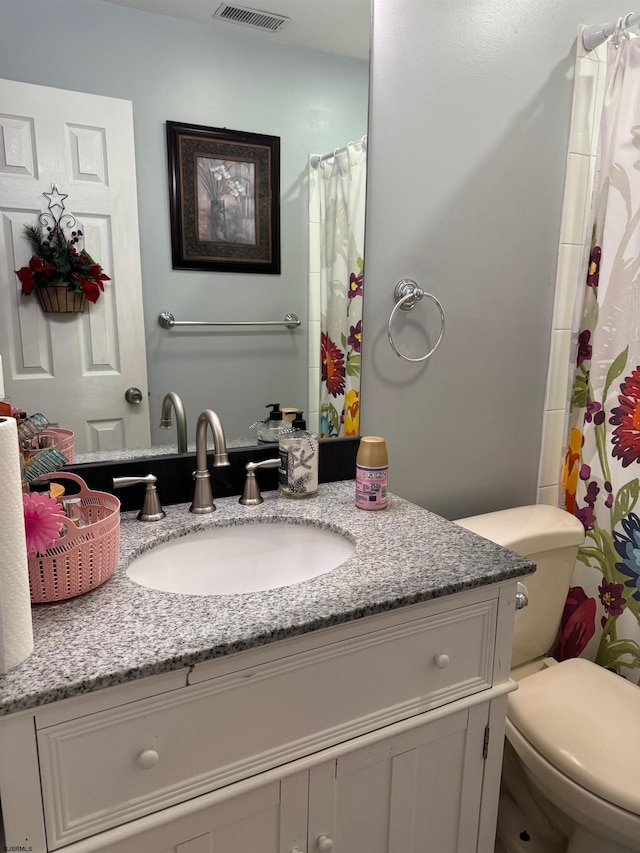 bathroom featuring vanity and toilet