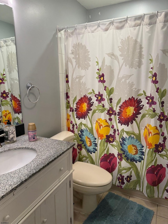 bathroom featuring tile patterned flooring, vanity, and toilet