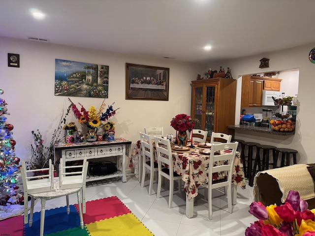 dining area with light tile patterned floors