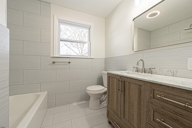 full bathroom with vanity, tile walls, independent shower and bath, tile patterned flooring, and toilet