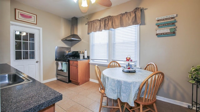 dining space featuring ceiling fan, light tile patterned flooring, and sink