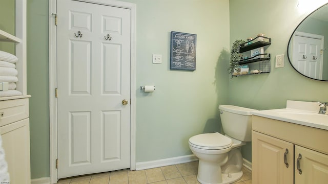 bathroom with tile patterned flooring, vanity, and toilet