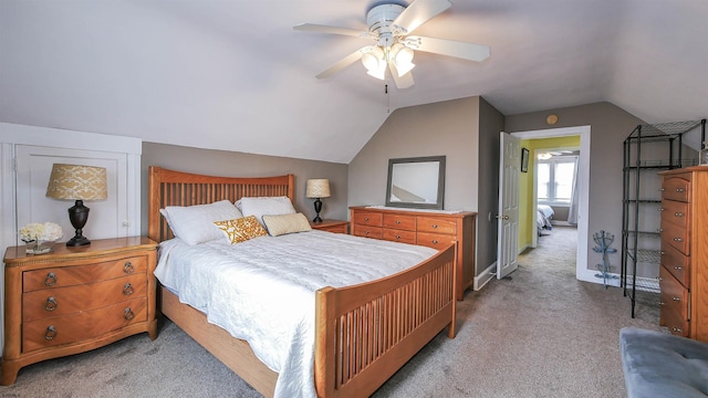 bedroom with light carpet, vaulted ceiling, and ceiling fan