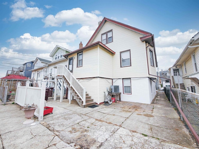 back of property featuring central AC and a patio area