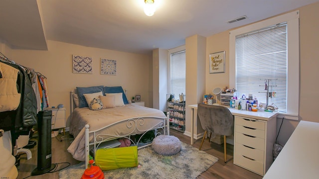 bedroom with dark wood-type flooring