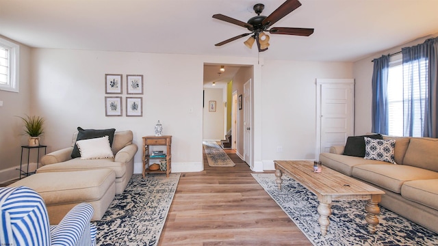 living room featuring light wood-type flooring and ceiling fan