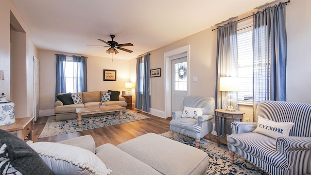 living room with wood-type flooring, plenty of natural light, and ceiling fan