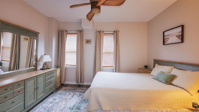 bedroom with dark hardwood / wood-style floors and ceiling fan