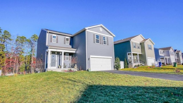 view of property featuring a front lawn and a garage