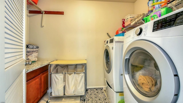 clothes washing area featuring independent washer and dryer