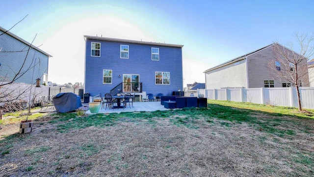 rear view of house with a yard and a patio