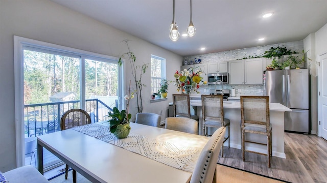 dining space with light hardwood / wood-style floors