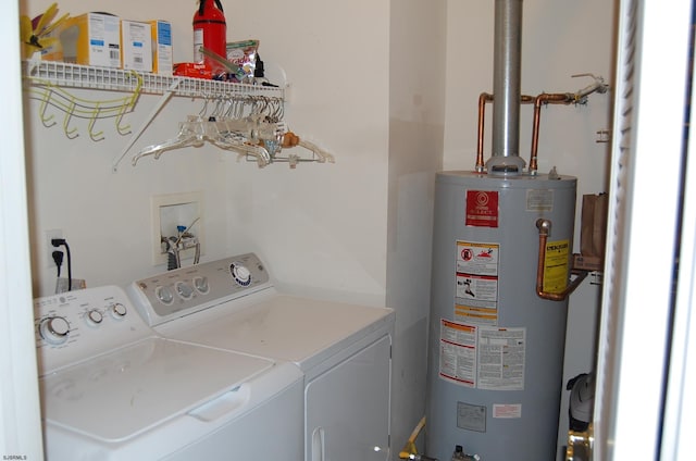 clothes washing area featuring independent washer and dryer and gas water heater