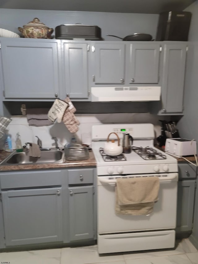 kitchen featuring sink, gray cabinets, and white gas stove