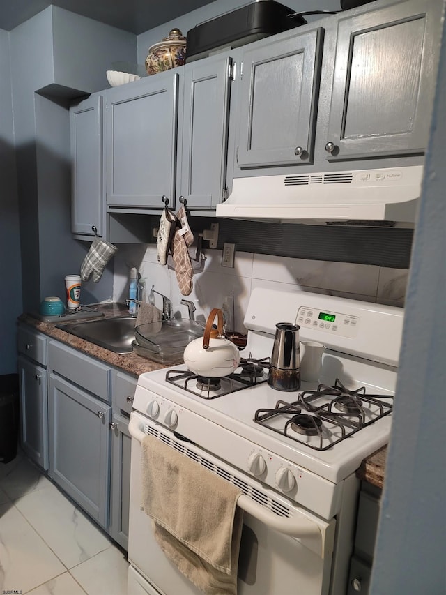 kitchen featuring gray cabinets, white range with gas cooktop, and sink