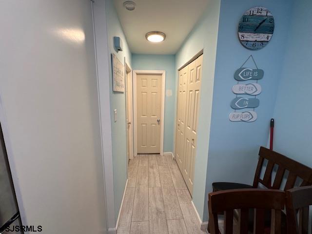 hallway with light wood-type flooring