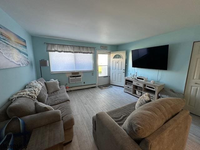 living room featuring light hardwood / wood-style flooring, a baseboard radiator, and a wall mounted air conditioner