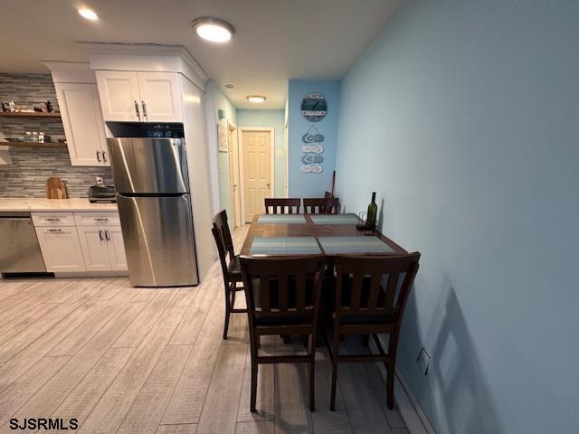 dining space with light wood-type flooring