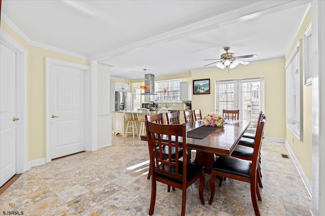 dining space featuring ceiling fan and ornamental molding