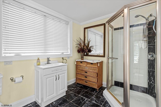 bathroom with vanity, an enclosed shower, and crown molding