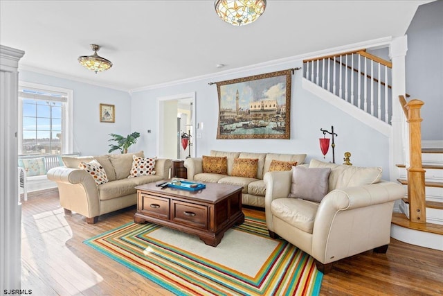 living room with a chandelier, wood-type flooring, and crown molding