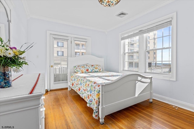 bedroom featuring light hardwood / wood-style flooring and ornamental molding