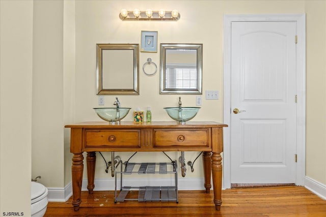 bathroom with sink, wood-type flooring, and toilet