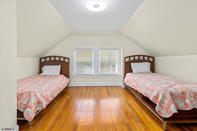 bedroom featuring wood-type flooring and lofted ceiling