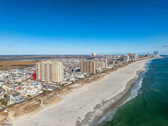 birds eye view of property featuring a water view and a beach view