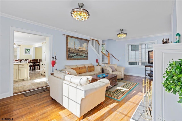 living room featuring light hardwood / wood-style flooring and ornamental molding