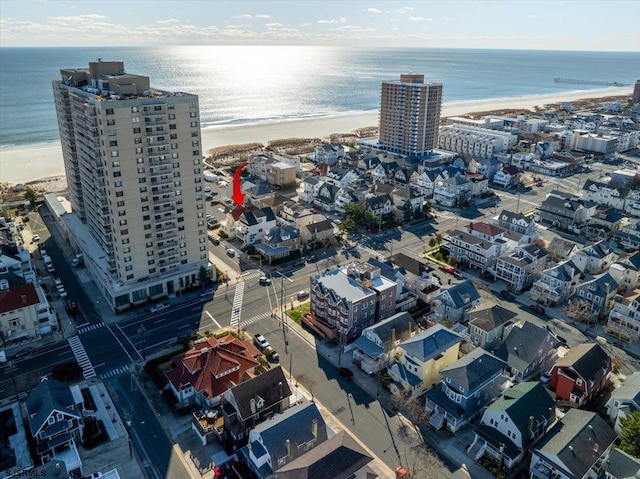 aerial view featuring a view of the beach and a water view