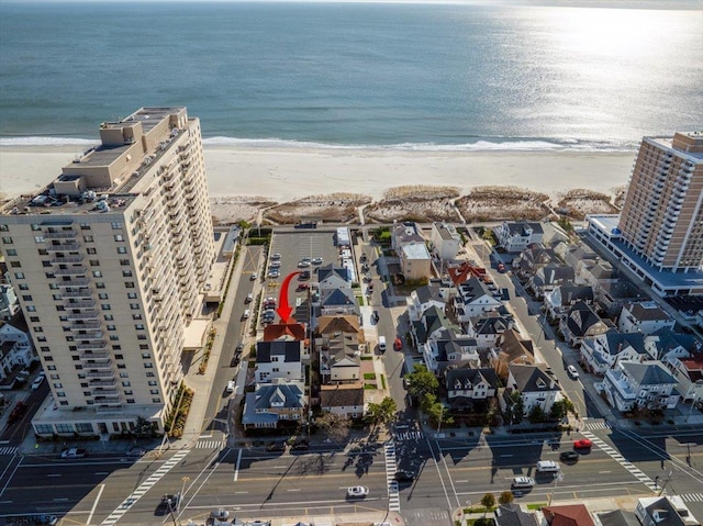 drone / aerial view featuring a water view and a beach view