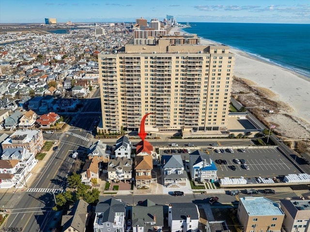 drone / aerial view with a water view and a beach view