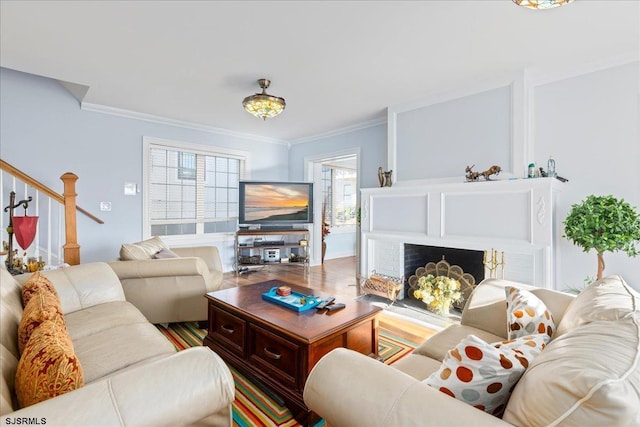 living room featuring crown molding and a brick fireplace