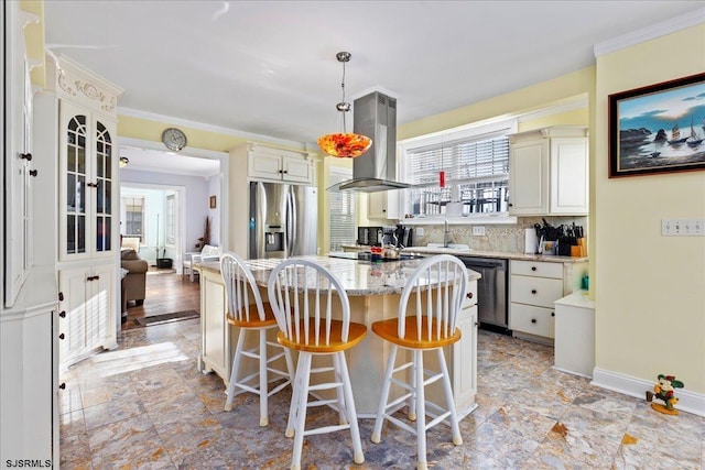 kitchen featuring appliances with stainless steel finishes, tasteful backsplash, island range hood, pendant lighting, and a center island