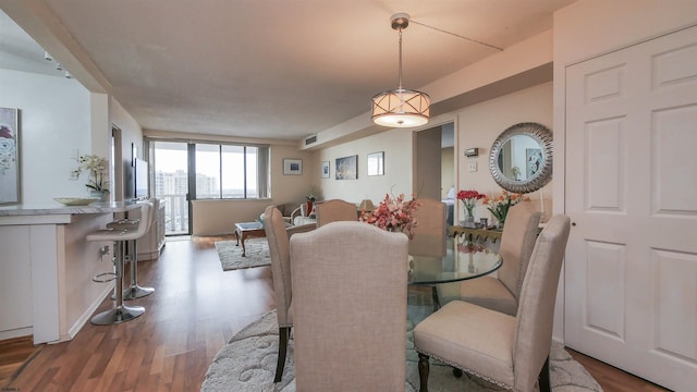 dining area with dark hardwood / wood-style flooring