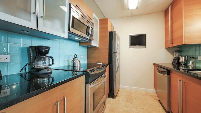 kitchen featuring stainless steel appliances and tasteful backsplash